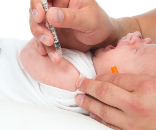 Doctor vaccinating child baby flu injection shot i